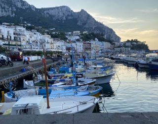 Kleine bootjes in haven van Capri bij zonsondergang