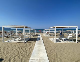 Strand van Paestum met ligstoelen en wit gangetje