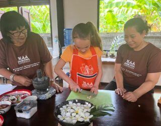 Kind snijdt ingrediënten in Thaise kookworkshop