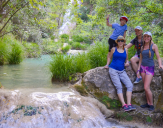 Familie bij de azuurblauwe Polimnio watervallen