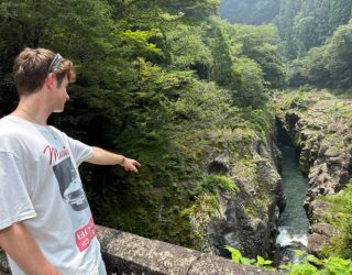 Zoon van Liesbeth wijst naar Takachiho Gorge