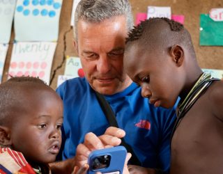 Himba's kijken naar Geert zijn telefoon