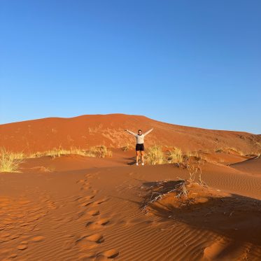 Met handen omhoog in de woestijn Sossuvlei