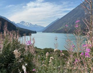 Familie Vossaert bij meer tussen bergen in West-Canada