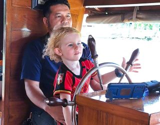Kind bestuurt de boot tijdens diner