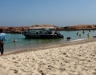 Strand met lichtblauw water in Oman